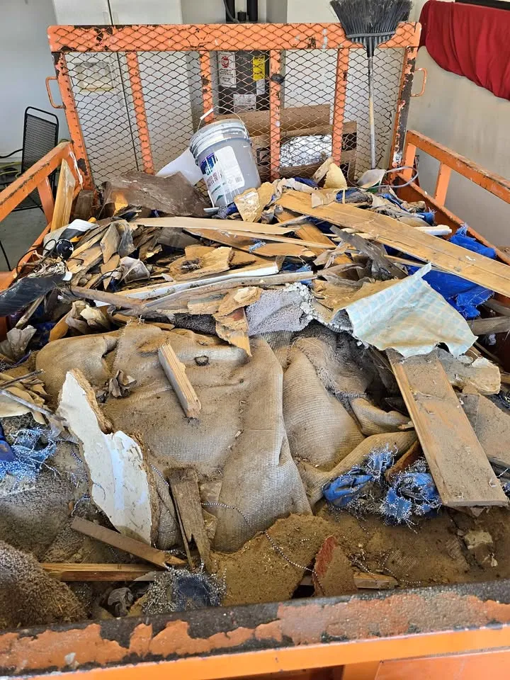 Dump trailer loaded with carpet, drywall and lumber from a clean-out
