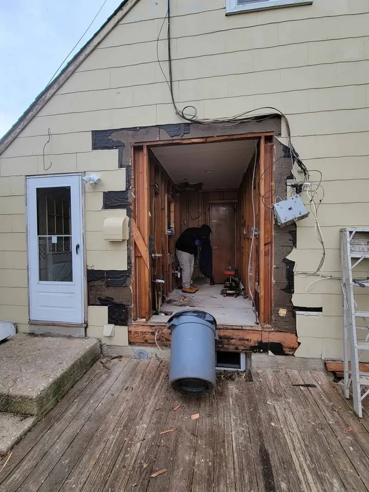 Large opening cut through an exterior wall, framed and ready for a new door